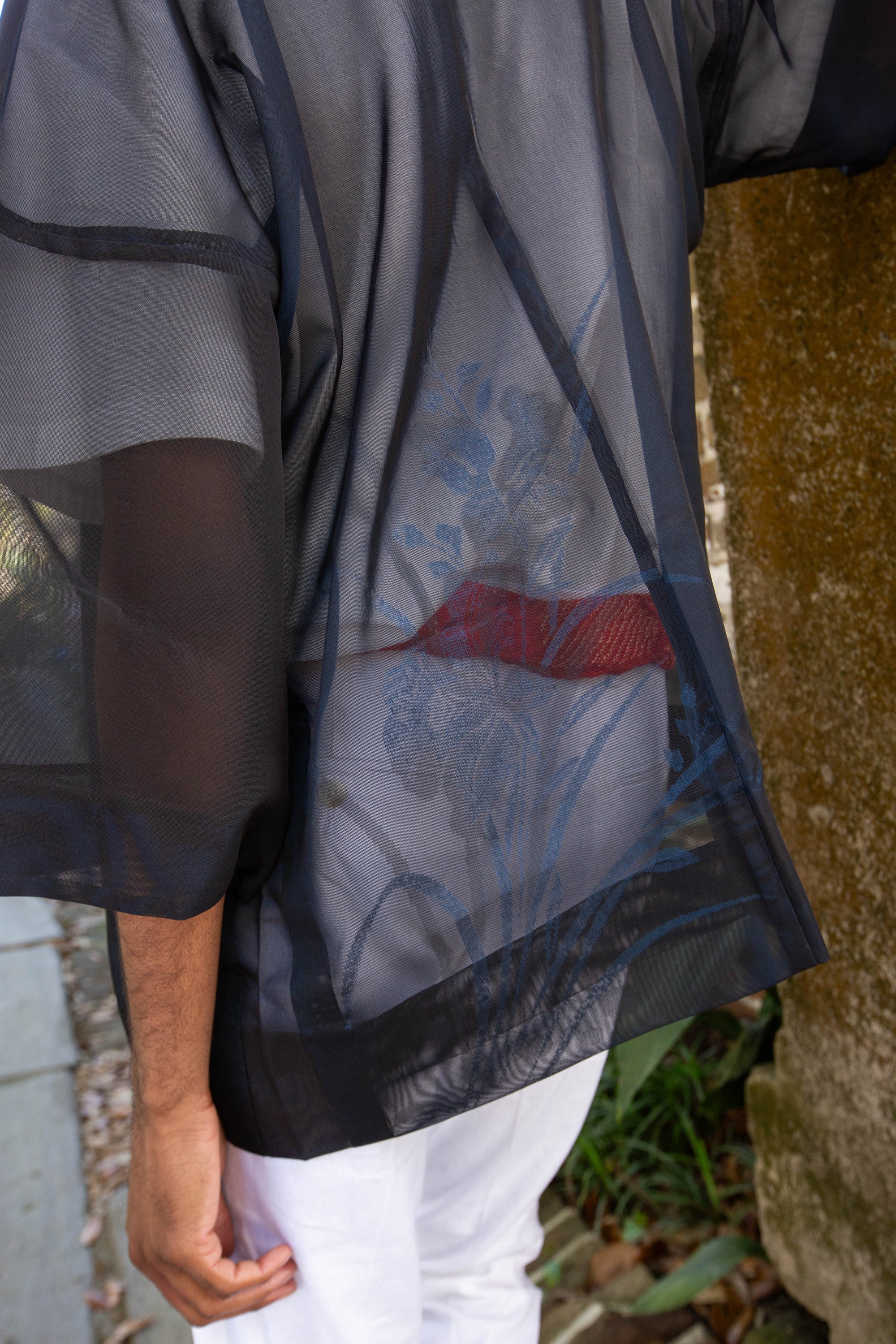 detail of woven iris on silk kimono jacket worn by man