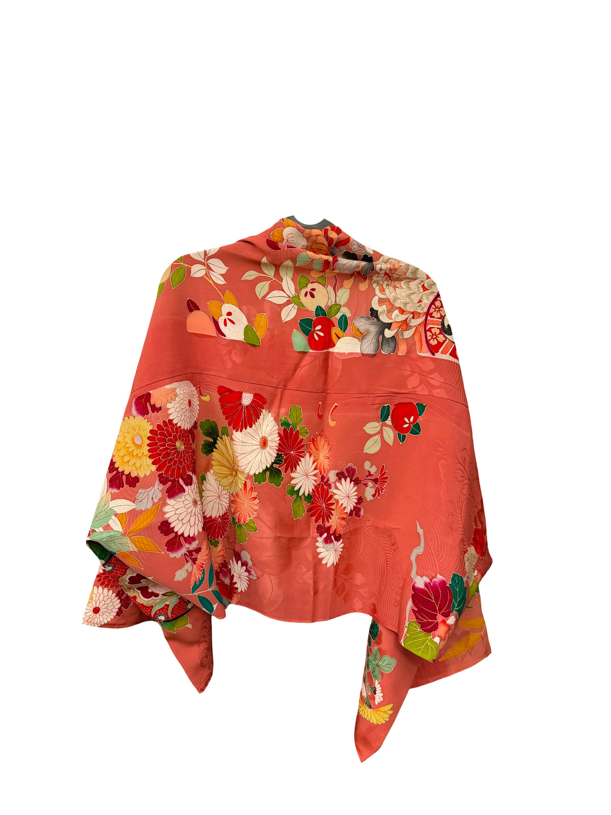A coral orange kimono-style shawl with a vibrant floral print, featuring red, white, yellow, and green flowers, displayed against a solid white background.