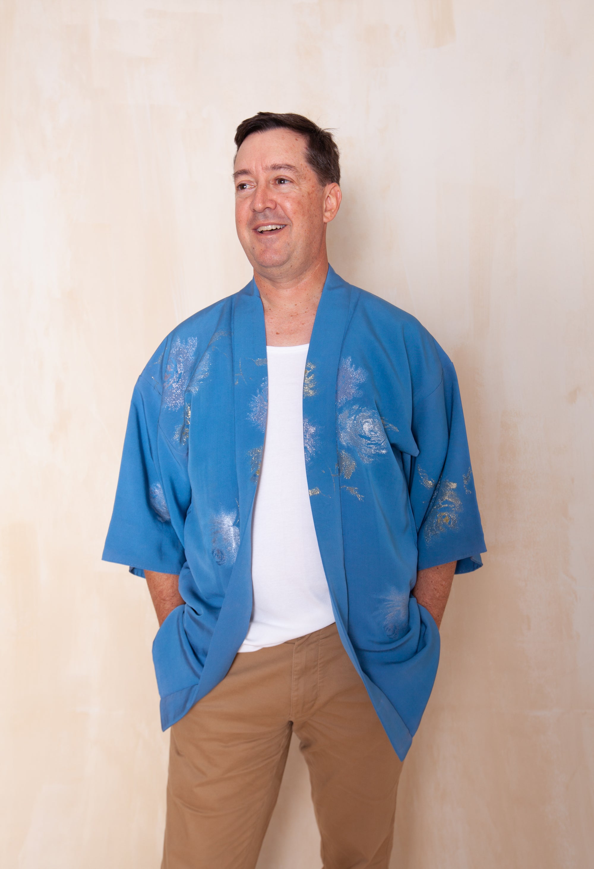 man wearing blue silk kimono jacket with silver woven flowers