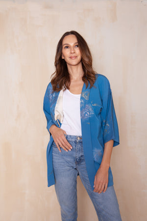 woman wearing blue silk vintage kimono jacket with modernized sleeves