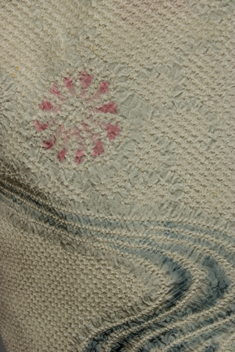 detail of shibori blue swirls on pink flowers on silk from vintage kimono jacket