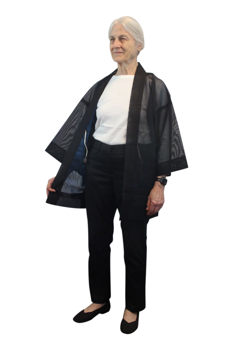 small woman in semi-transparent blue black kimono jacket