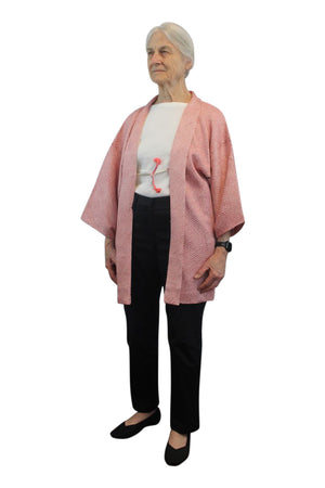 small woman wearing refashioned pink kimono jacket