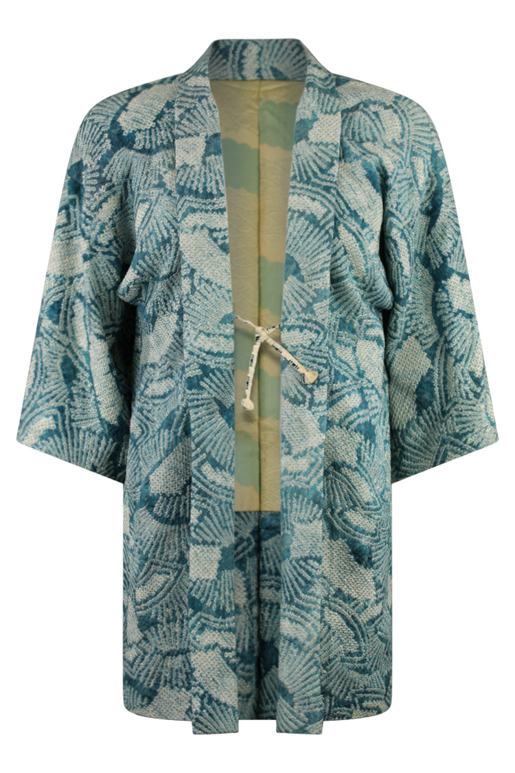 turquoise kimono cardigan with complex knotted design and reduced sleeves for modern use