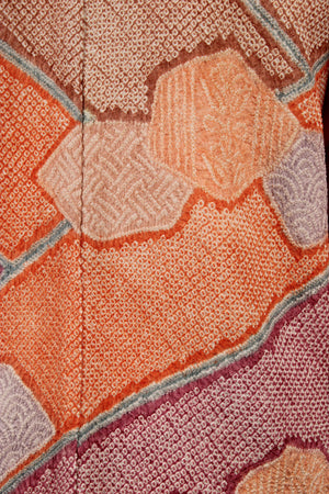 detail of superior workmanship on hand knotted silk kimono coat in mauve, orange and pink