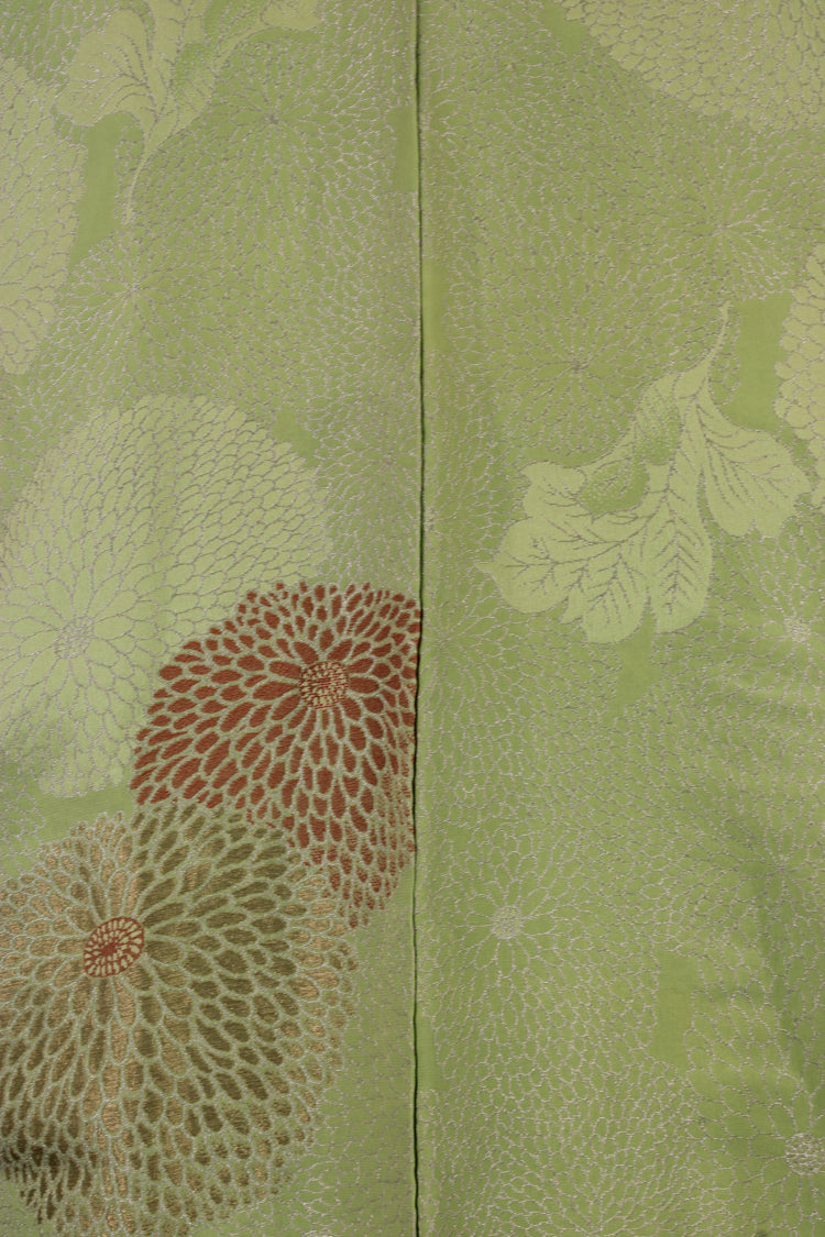 detail of metallic thread woven into chyrsanthemums on lime green silk