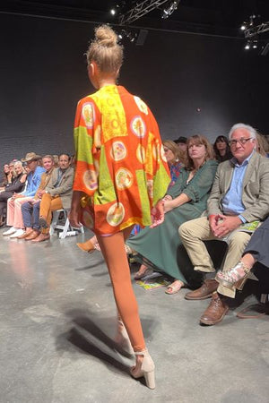 runway model in orange vintage silk kimono jacket with modernized sleeves