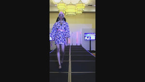 model on runway in checkered dress jacket