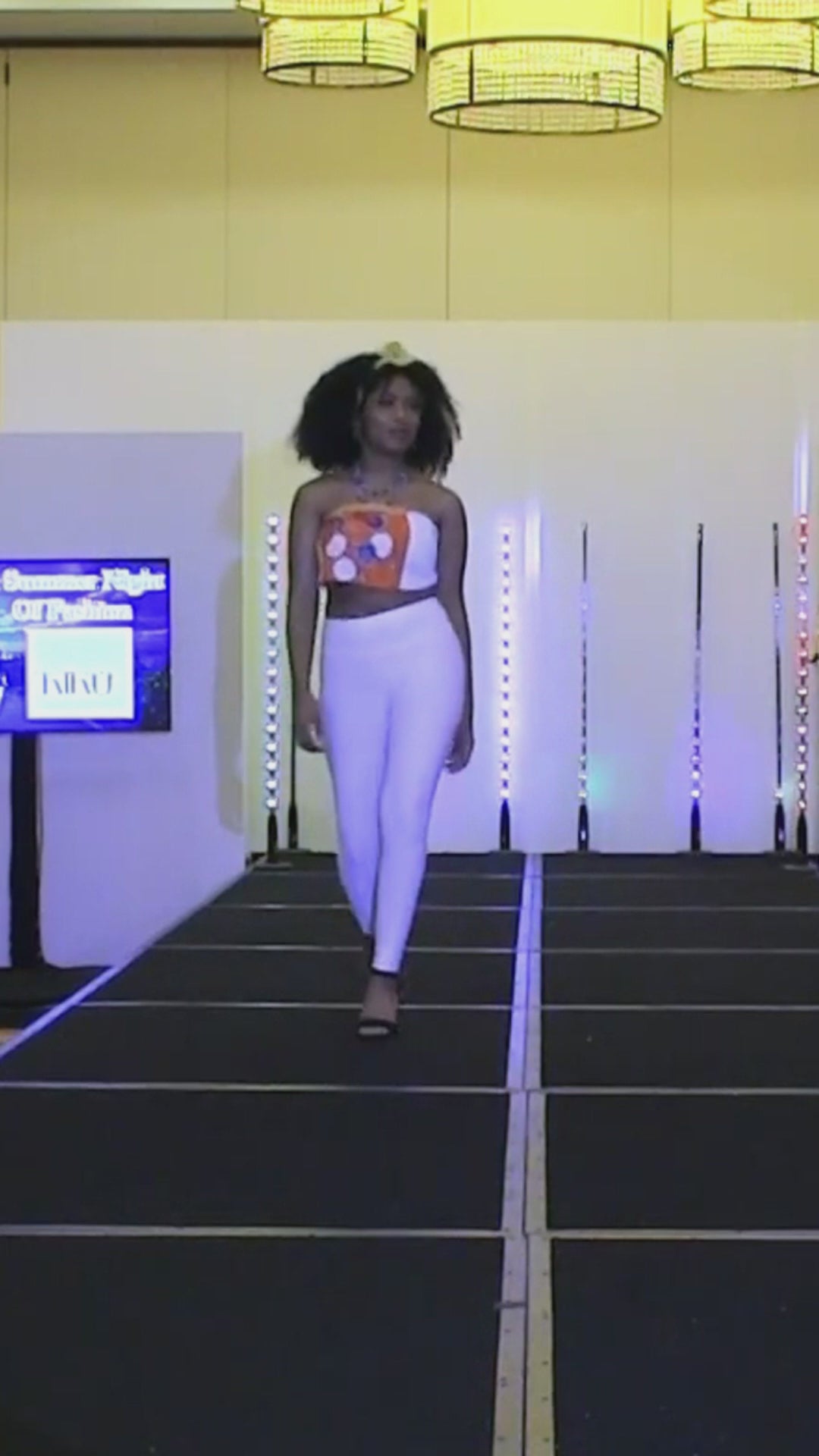 runway model in silk orange scarf tied top 