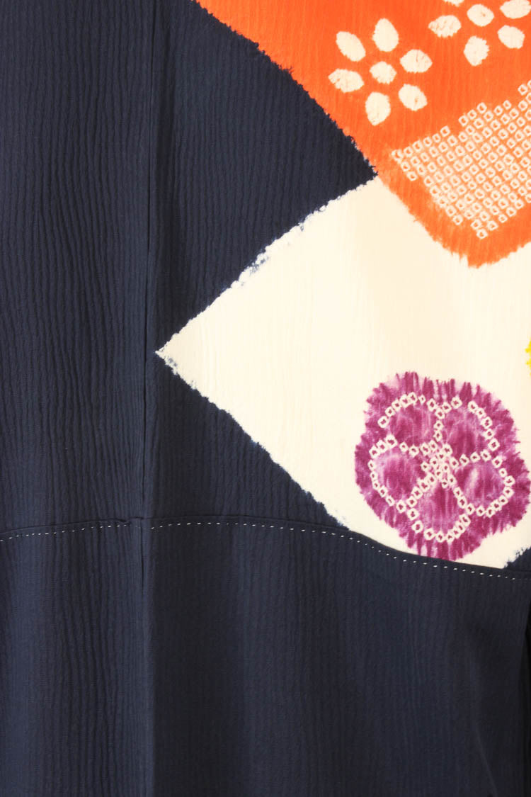detail of silk design of orange and white on navy blue from vintage kimono
