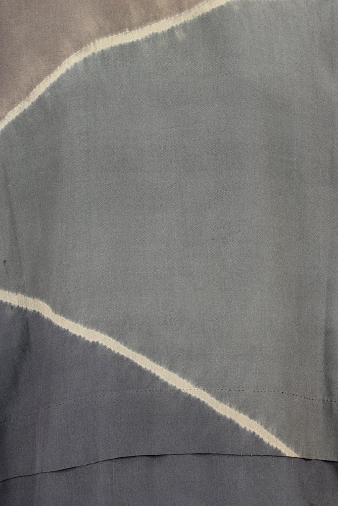 detail of vintage silk with patches of browns and grays