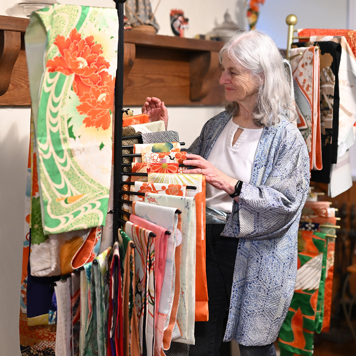 Woman looking at colorful fabric panels in a store