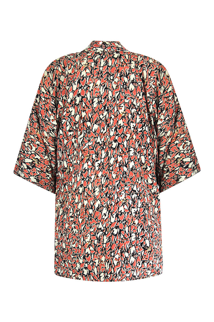 Back view showcasing the black and peach patterned silk jacket.