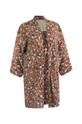 Peach and black patterned silk jacket three quarter turn, full length view of garment on a white background. 